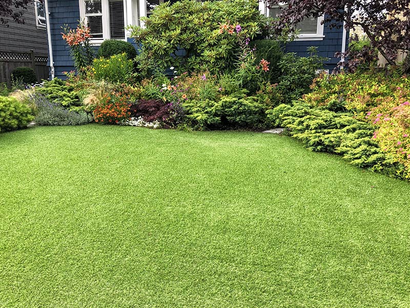 residential property backyard with artificial lawn installed southhampton ny